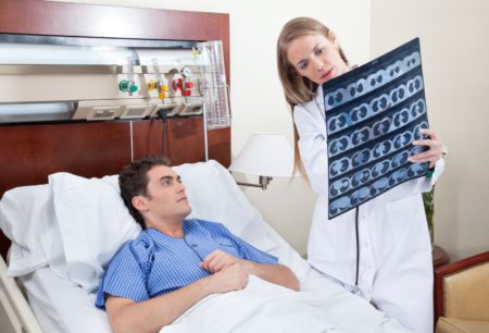 9886948 - doctor and patient examining x-ray report in hospital